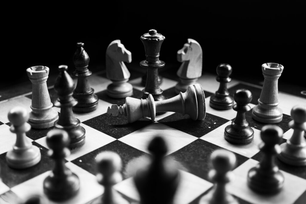 The image is sourced from Unsplash: https://unsplash.com/photos/chess-pieces-on-board-nAjil1z3eLk